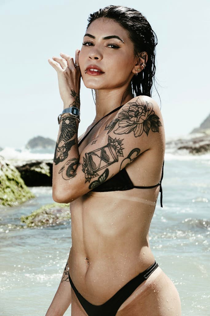 Photo of a Woman Wearing a Bikini, with a Tattoo on an Arm